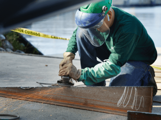 An employee working on a piece of the boat