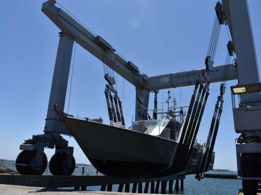 Government boat hanging out of water