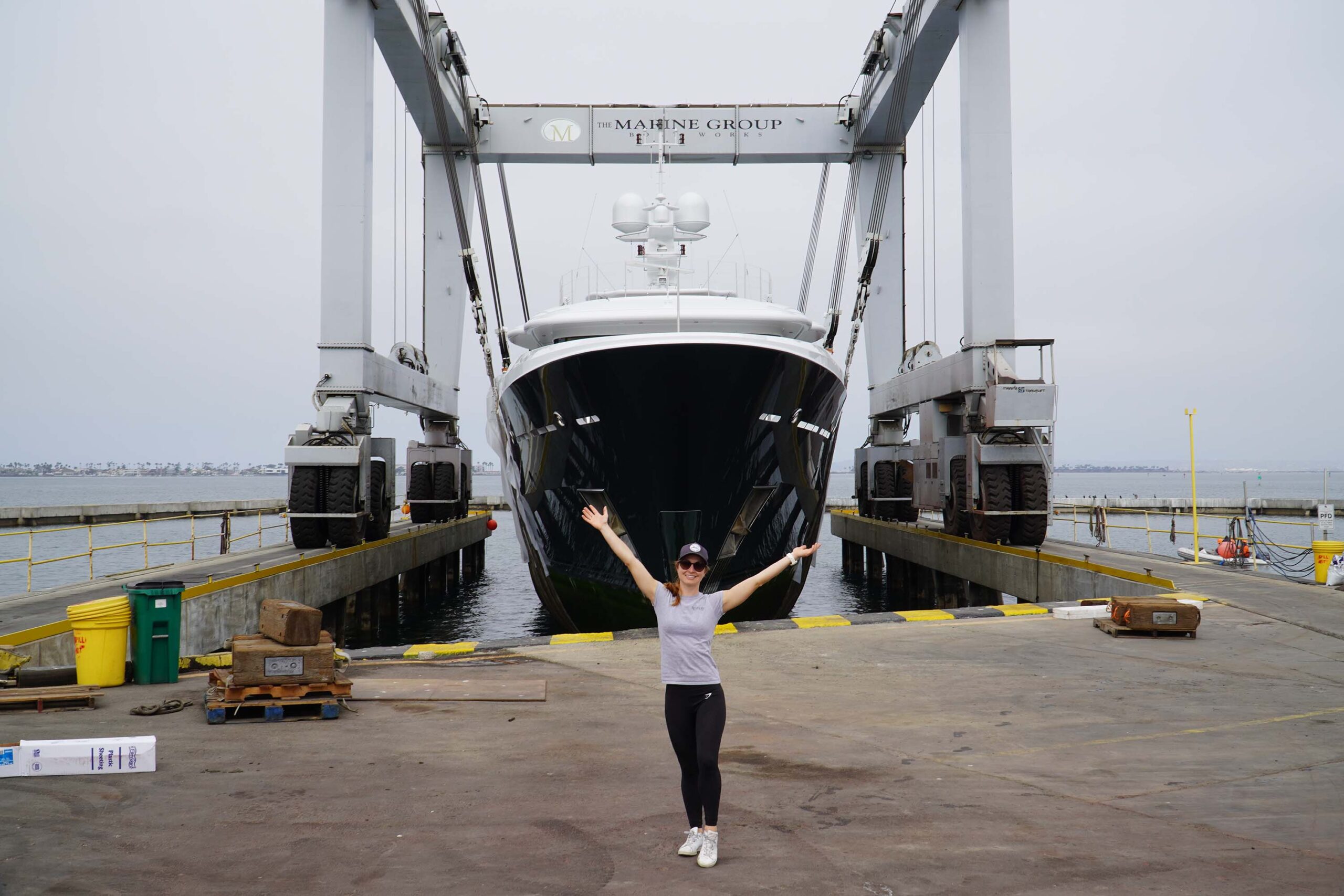 MY Revelry head chef Nina posing in front of the MGBW travelift.